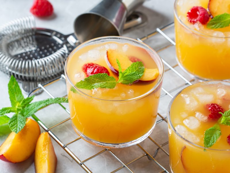 Summer refreshing drink, beverage, cocktail with peach and raspberry